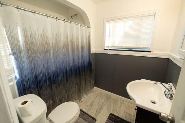 bathroom featuring vanity, toilet, and a shower with shower curtain