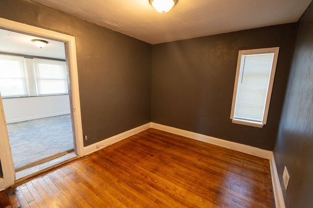 spare room with hardwood / wood-style floors