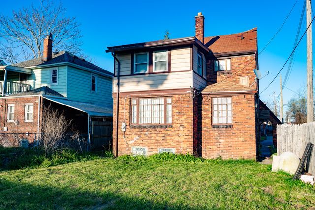 rear view of house with a lawn