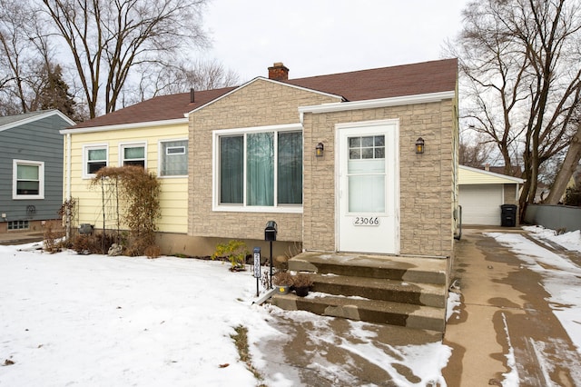 view of front facade with a garage and an outbuilding