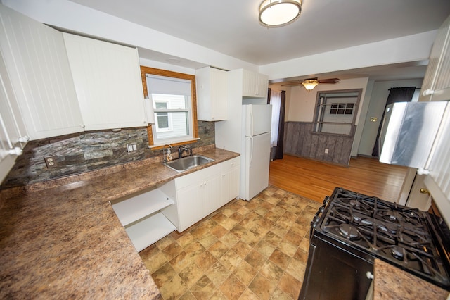 kitchen with sink, range with gas cooktop, white cabinets, and white fridge