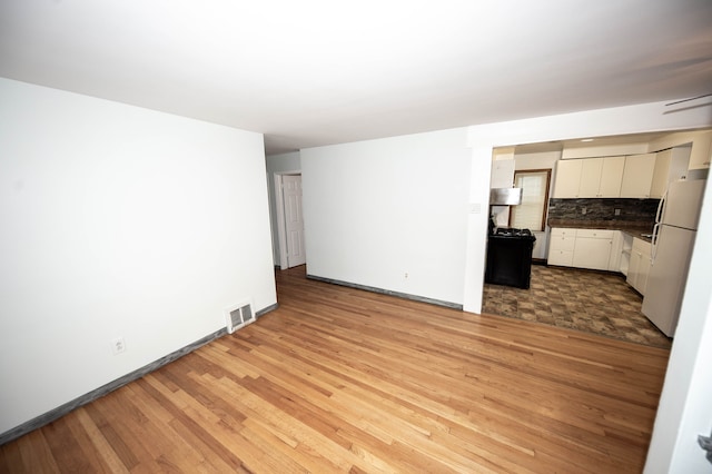 unfurnished living room with light hardwood / wood-style floors