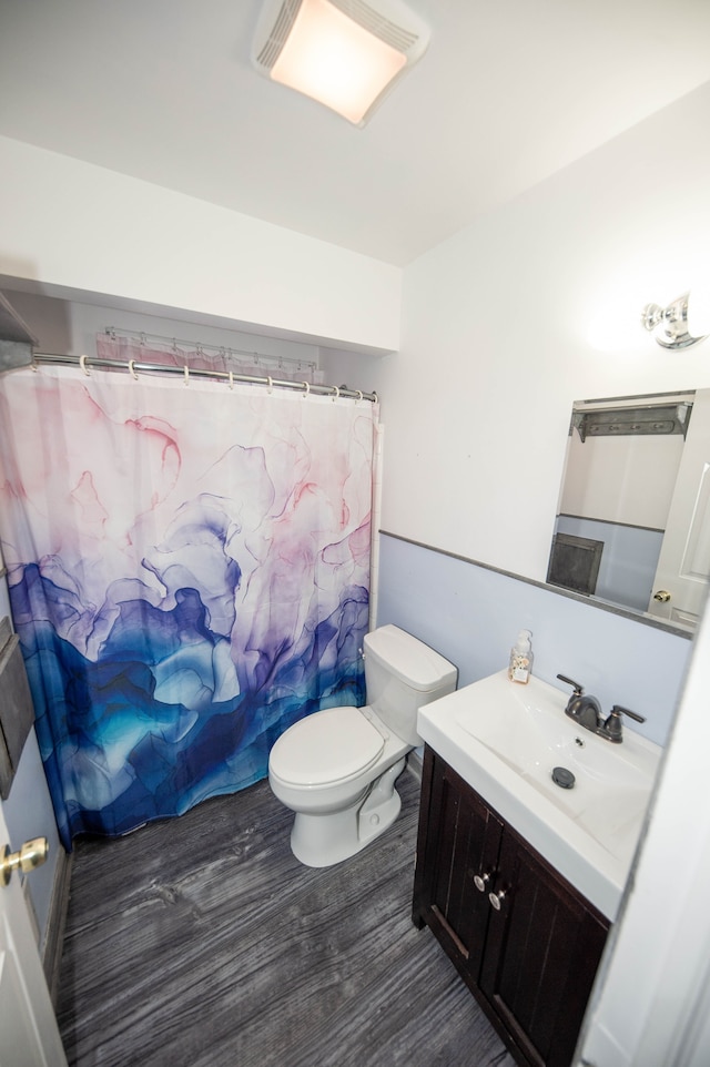 bathroom with a shower with shower curtain, vanity, toilet, and hardwood / wood-style floors