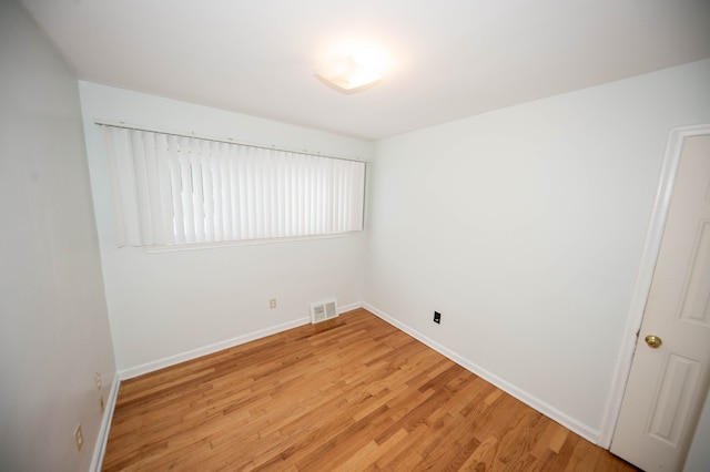 unfurnished room featuring light hardwood / wood-style floors