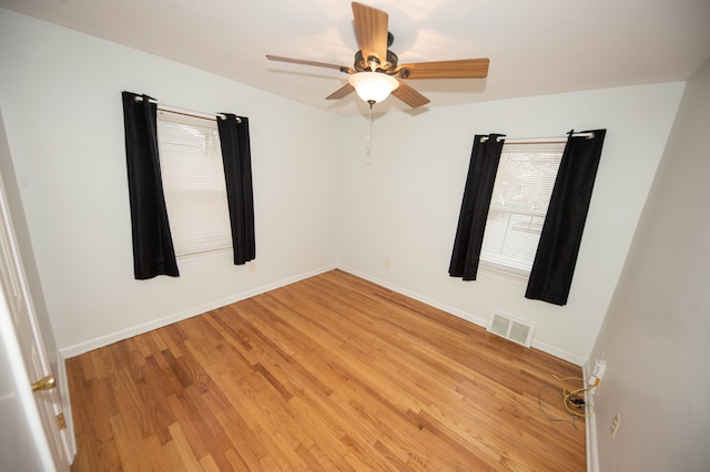 unfurnished room featuring ceiling fan and hardwood / wood-style floors