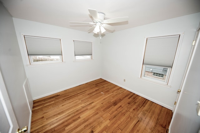 unfurnished room with hardwood / wood-style floors and ceiling fan