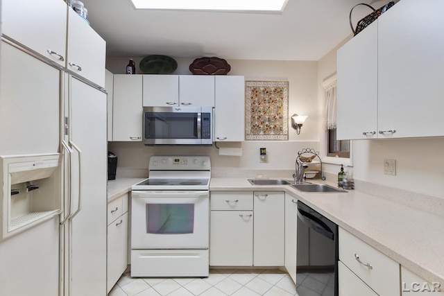 kitchen with white cabinetry, sink, white appliances, and light tile patterned flooring