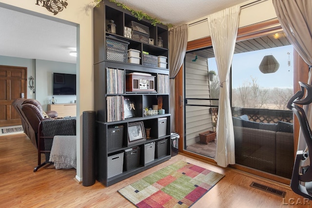 interior space with hardwood / wood-style flooring and a textured ceiling