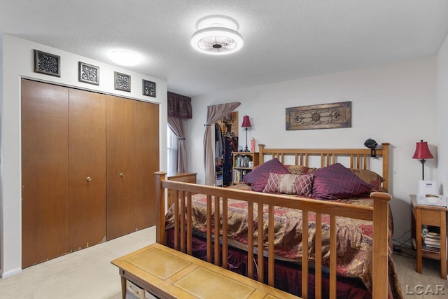 bedroom with a closet and a textured ceiling