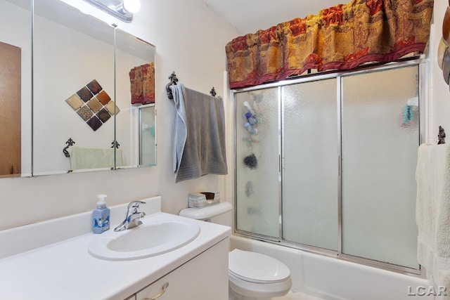 full bathroom with vanity, toilet, and combined bath / shower with glass door