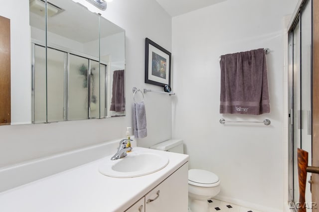 bathroom featuring walk in shower, vanity, and toilet