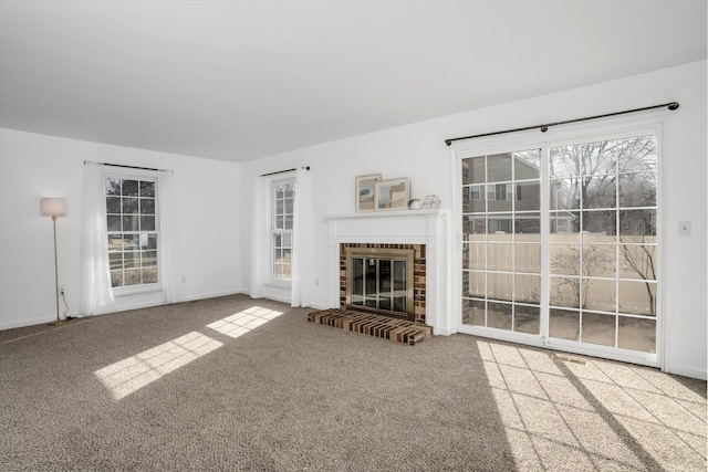 unfurnished living room featuring a fireplace and carpet flooring