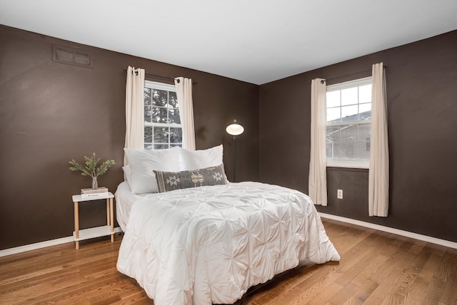 bedroom with wood-type flooring