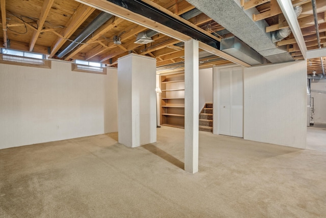 basement featuring light carpet