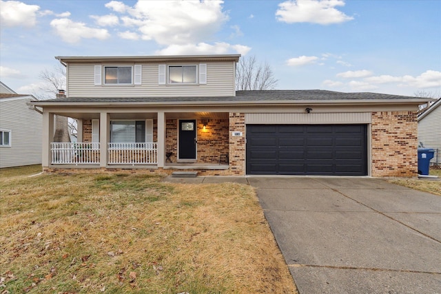 view of front of home featuring a garage, covered porch, and a front lawn