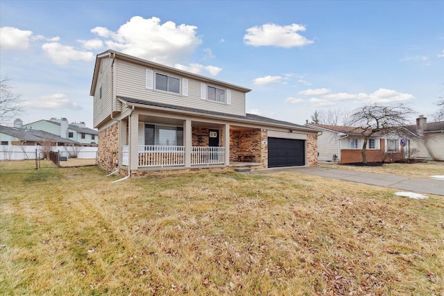 view of front property featuring a garage, a front yard, and covered porch