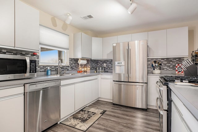 kitchen with white cabinetry, stainless steel appliances, and sink