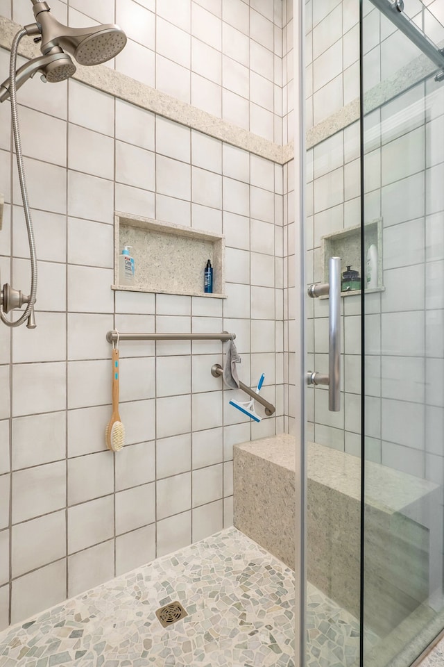 bathroom featuring a shower with shower door