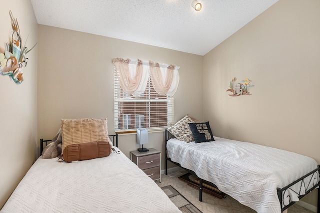 carpeted bedroom with lofted ceiling and a textured ceiling