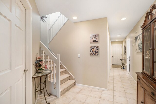 entryway featuring a skylight and light tile patterned floors