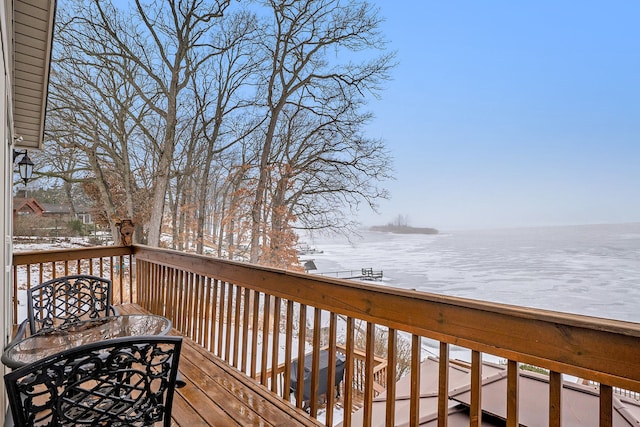 wooden terrace featuring a water view