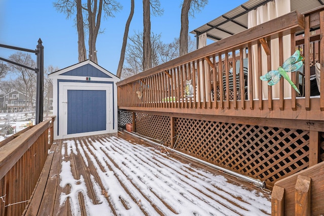 snow covered deck with a shed