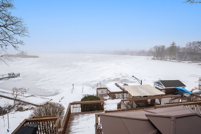 yard covered in snow with a deck