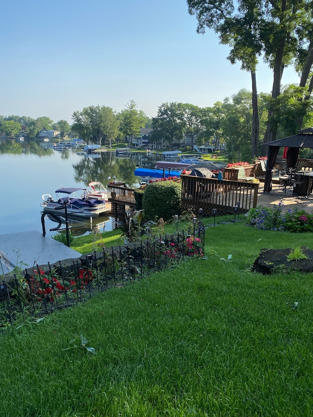 view of yard with a dock and a water view