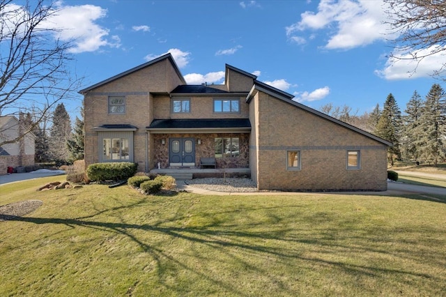 view of front of house featuring brick siding and a front yard