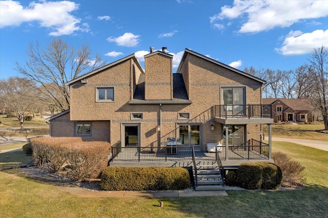 back of property with a yard, brick siding, and a chimney