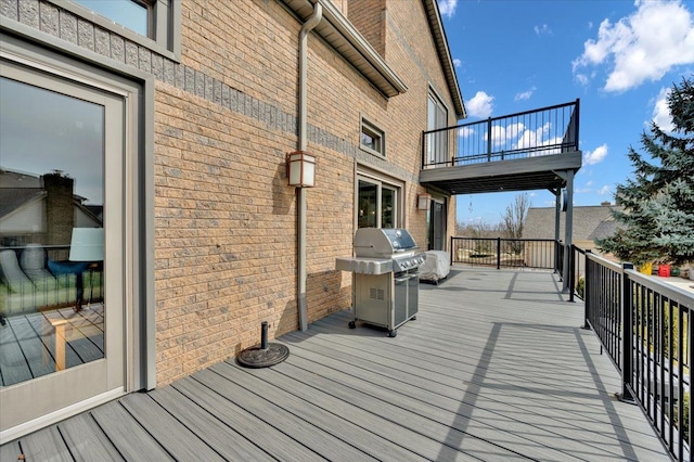 wooden terrace with a grill