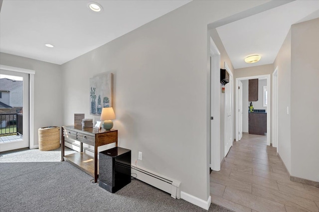 corridor with light carpet, baseboard heating, recessed lighting, and baseboards