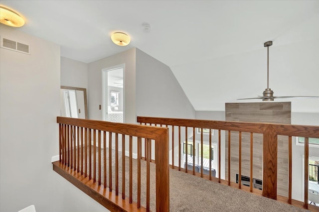 hall featuring vaulted ceiling and visible vents