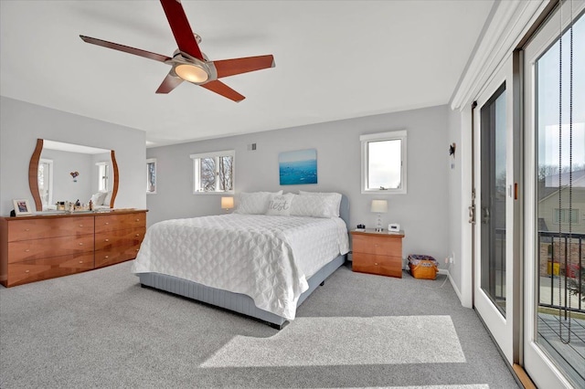 bedroom featuring multiple windows, ceiling fan, carpet, and access to outside