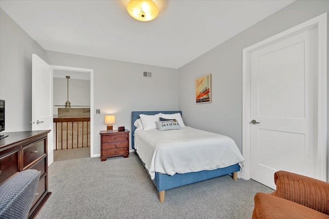 carpeted bedroom with visible vents and baseboards