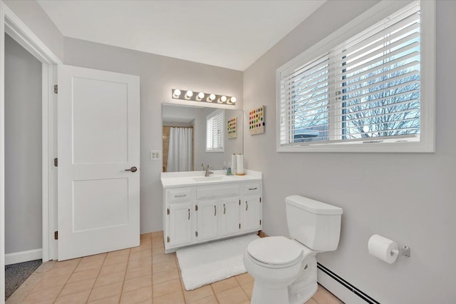 bathroom with vanity, toilet, plenty of natural light, and baseboard heating