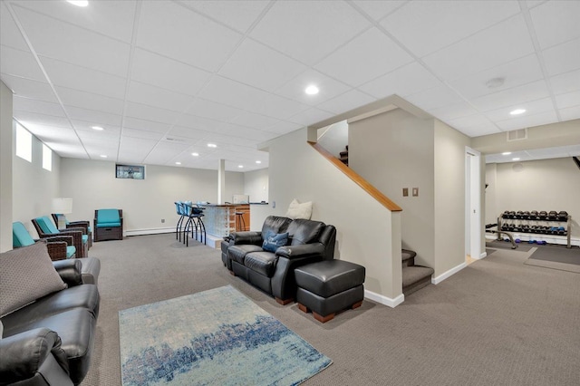 carpeted living room with stairway, visible vents, baseboards, recessed lighting, and a paneled ceiling