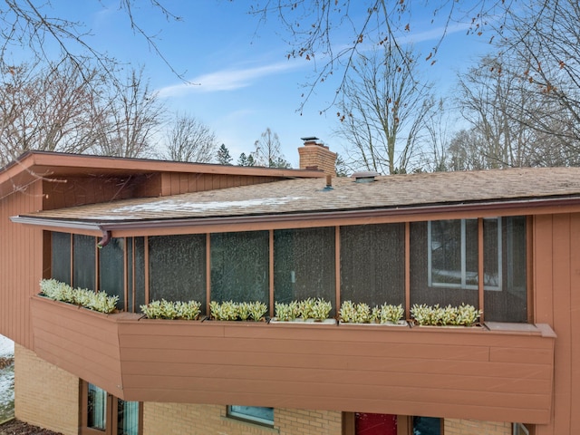 view of side of property featuring a sunroom