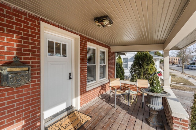 wooden terrace featuring covered porch