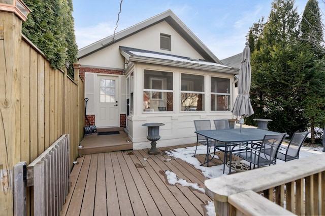 wooden deck featuring a sunroom