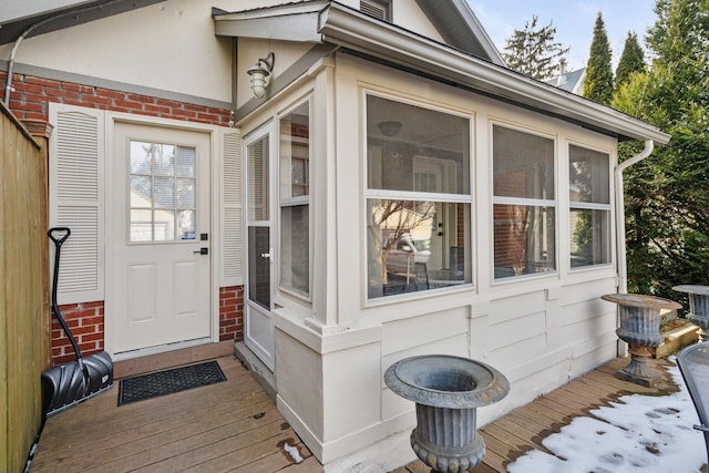 view of exterior entry with a deck