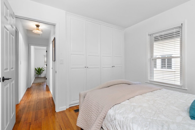 bedroom featuring light wood-type flooring and a closet