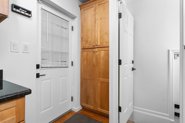 doorway with hardwood / wood-style flooring