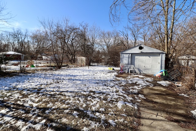 snowy yard with an outbuilding and a garage