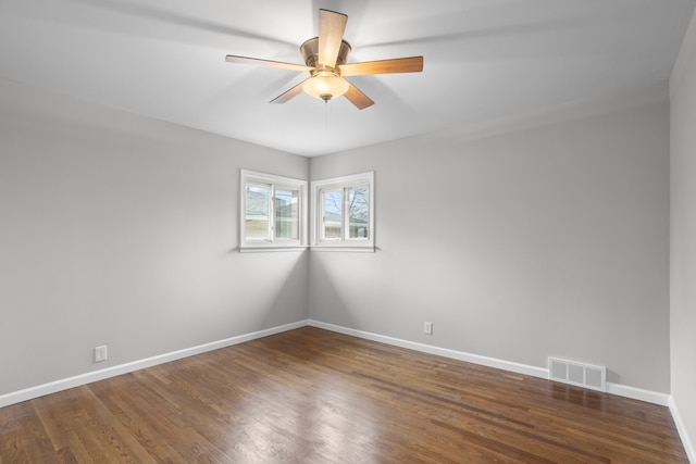 spare room with dark hardwood / wood-style floors and ceiling fan