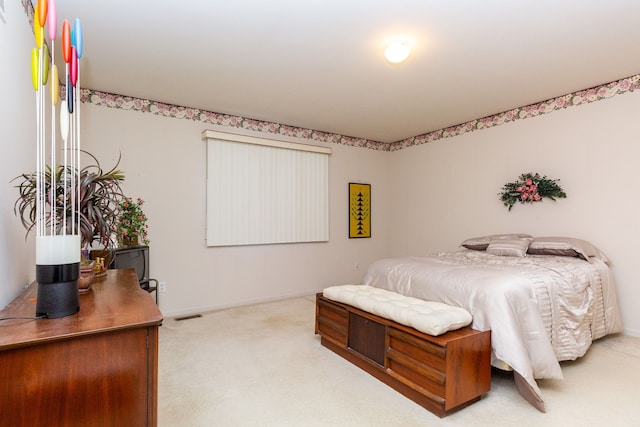 bedroom with light colored carpet