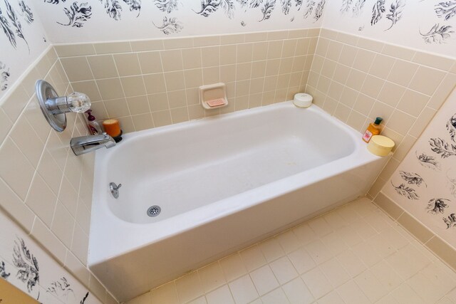 full bath with a tub and tile patterned floors