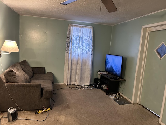 living room featuring ceiling fan, carpet flooring, and a textured ceiling