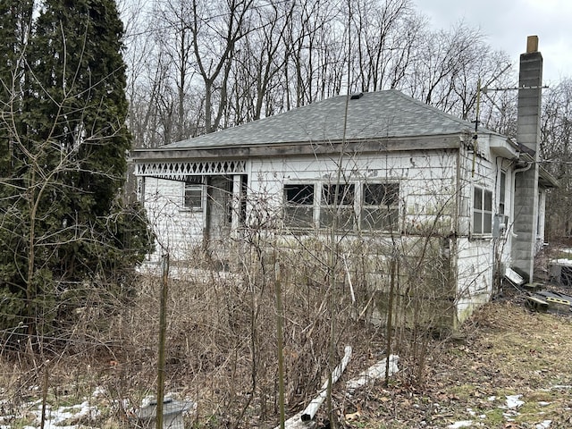 view of side of home with a garage and an outbuilding