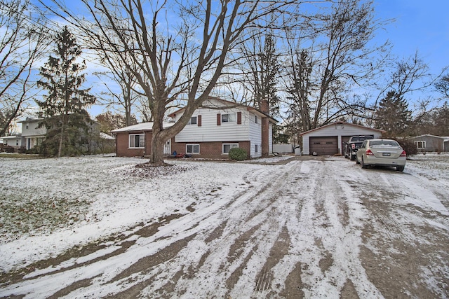 view of front of house with a garage and an outbuilding